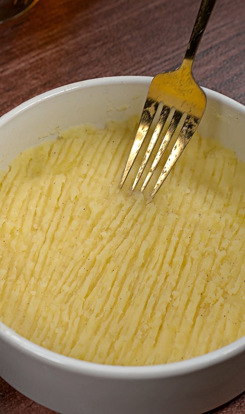 Mash the potatoes into a puree with a fork